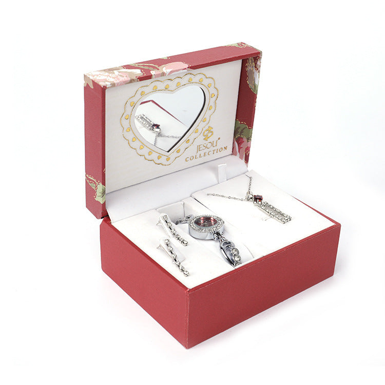 Ladies Jewelry Set featuring alloy material with diamond processing, including earrings, item decorations, hand decorations, and a bamboo link chain with a pendant. Available in red and purple colors, packed individually. Dimensions: 13.5 * 10.5 * 7 cm.