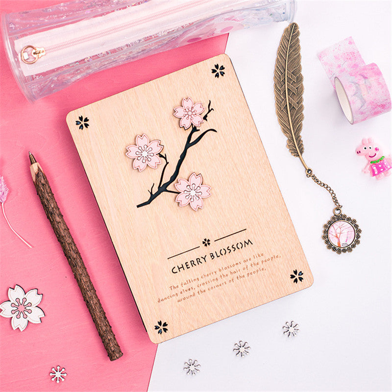 Creative Sakura Notebook Set with carved wooden cover, eco-friendly paper, and crystal bookmark.