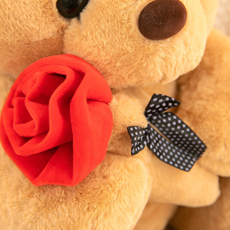 Teddy Bear with Rose – Soft plush bear with a rose, available in white, pink, brown, and gray, perfect for gifting on special occasions. Made with PP cotton and rabbit plush.