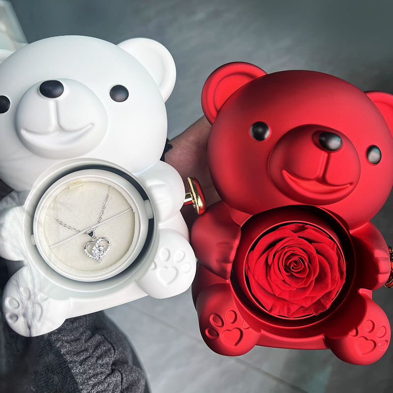 **Rotating Bear Gift Box β Playful & Elegant Packaging π** A **plastic jewelry box** with a **rotating bear design** and **preserved plastic flowers**, perfect for gifting jewelry. Measures **12x13x15.5cm**. Adds charm to your special present! π