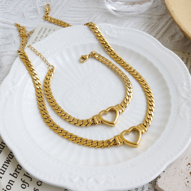 **Love Necklace & Bracelet** – Elegant **heart-shaped jewelry** with a sleek **Cuban chain**. Made from **stainless steel** with an **electroplated finish**, it's stylish, durable, and comfortable to wear. Perfect for any occasion or as a heartfelt gift. 💖