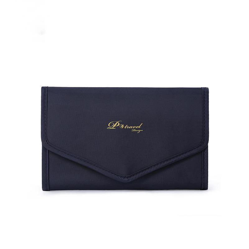 Elegant and portable navy blue travel jewelry bag with multiple compartments for organizing rings, necklaces, and earrings.