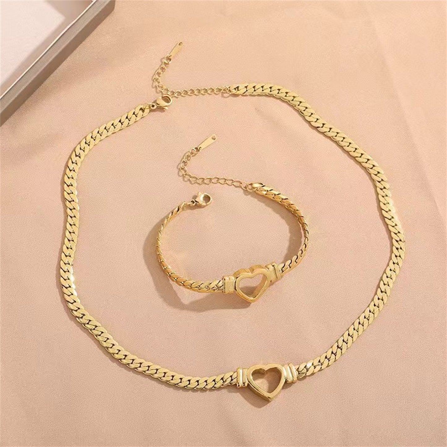 **Love Necklace & Bracelet** – Elegant **heart-shaped jewelry** with a sleek **Cuban chain**. Made from **stainless steel** with an **electroplated finish**, it's stylish, durable, and comfortable to wear. Perfect for any occasion or as a heartfelt gift. 💖