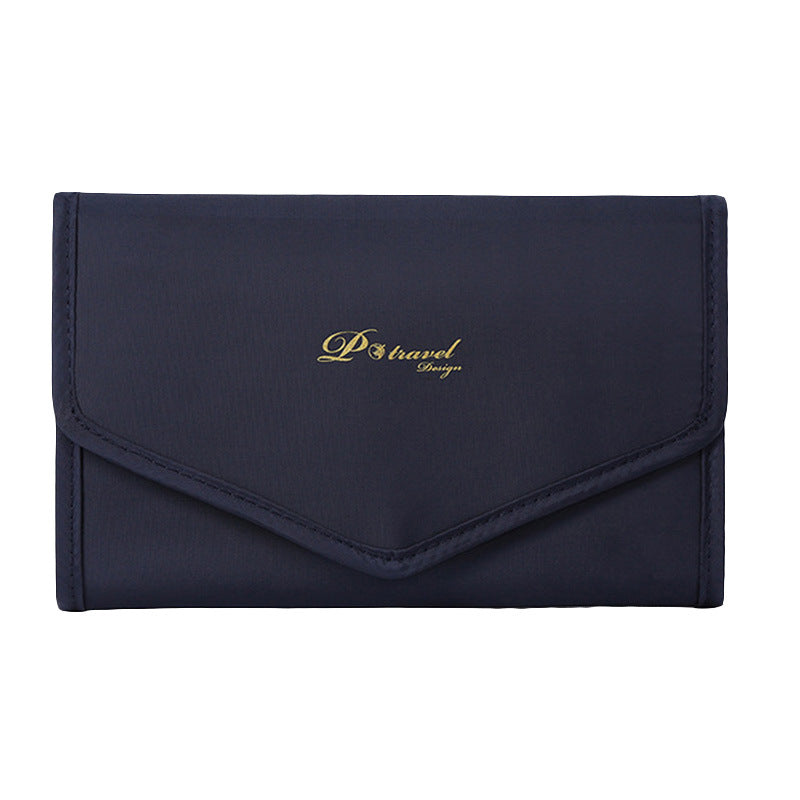 Elegant and portable navy blue travel jewelry bag with multiple compartments for organizing rings, necklaces, and earrings.