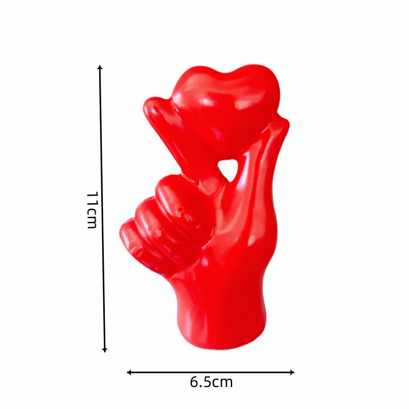**Love Gesture Resin Ornament** – A beautifully crafted **resin decor piece** symbolizing love and warmth. Available in **red, gold, silver, and white**, it’s compact (**11 × 6.5 × 4 cm**) and perfect for any space. Ideal as a **gift or home accent**. 💖
