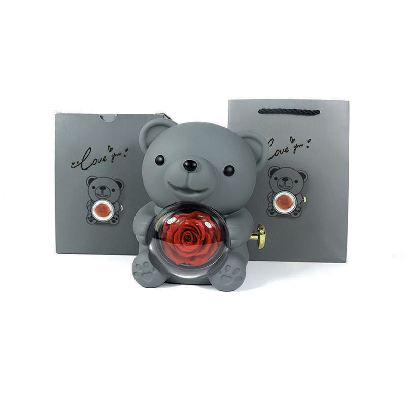 **Rotating Bear Gift Box β Playful & Elegant Packaging π** A **plastic jewelry box** with a **rotating bear design** and **preserved plastic flowers**, perfect for gifting jewelry. Measures **12x13x15.5cm**. Adds charm to your special present! π