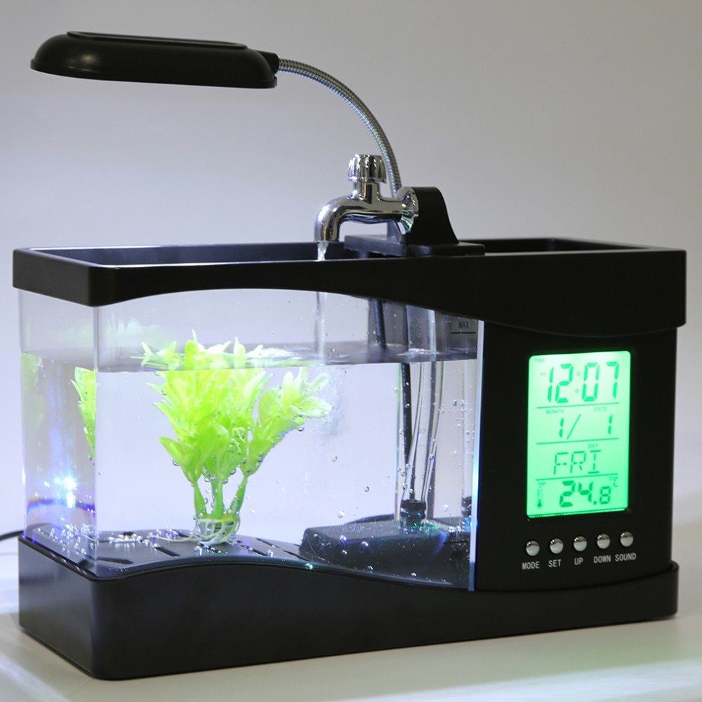 "Mini Aquarium Office Desk Organizer β A multifunctional desk accessory featuring an aquarium, LED table lamp, calendar, alarm, and pen holder, complete with small pebbles and a plant, creating a calming workspace atmosphere."