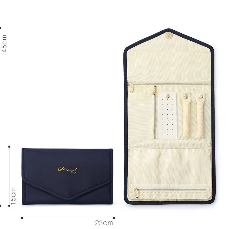 Elegant and portable navy blue travel jewelry bag with multiple compartments for organizing rings, necklaces, and earrings.