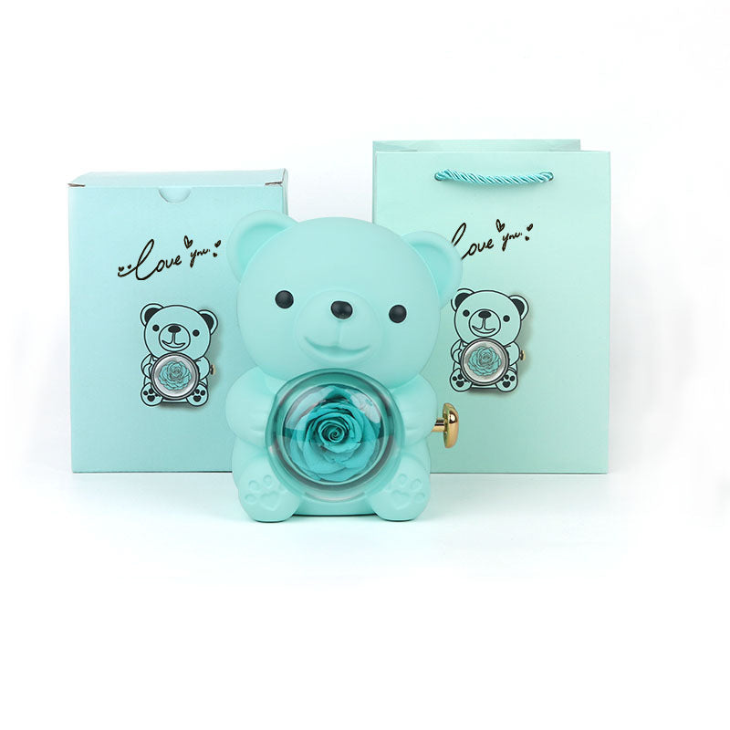 **Rotating Bear Gift Box β Playful & Elegant Packaging π** A **plastic jewelry box** with a **rotating bear design** and **preserved plastic flowers**, perfect for gifting jewelry. Measures **12x13x15.5cm**. Adds charm to your special present! π