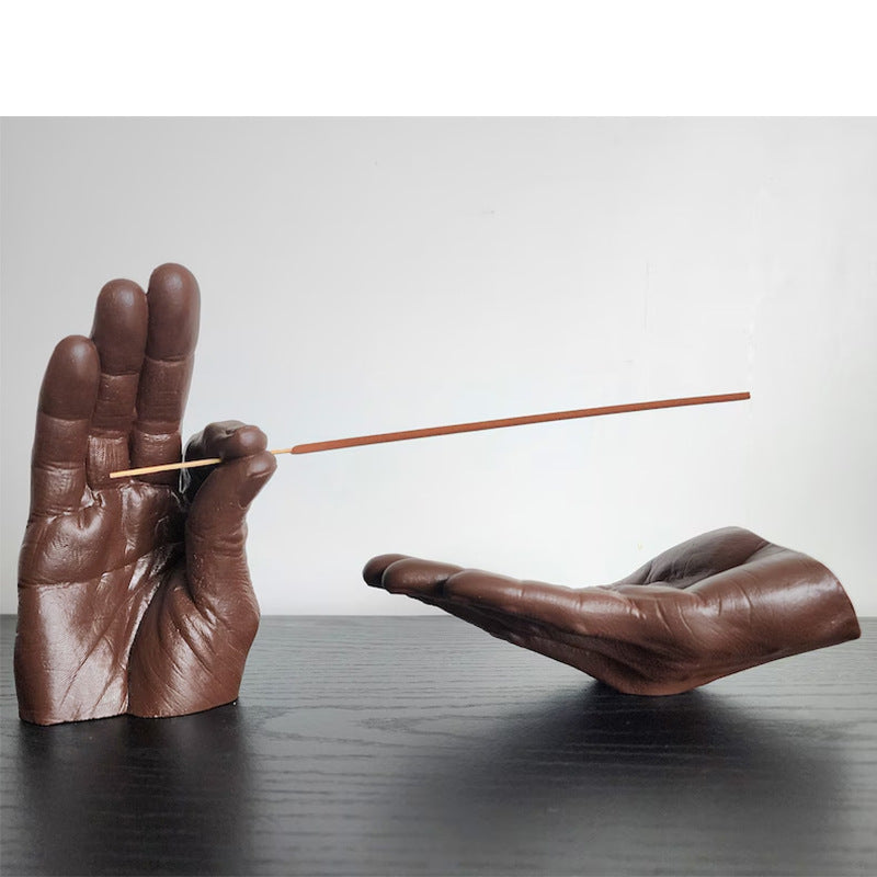 Cartoon-style resin incense holder in the shape of hands, available in black, white, light yellow, and brown. Made from synthetic resin, with a size of 19 * 10 * 10 cm, perfect for holding and receiving incense.