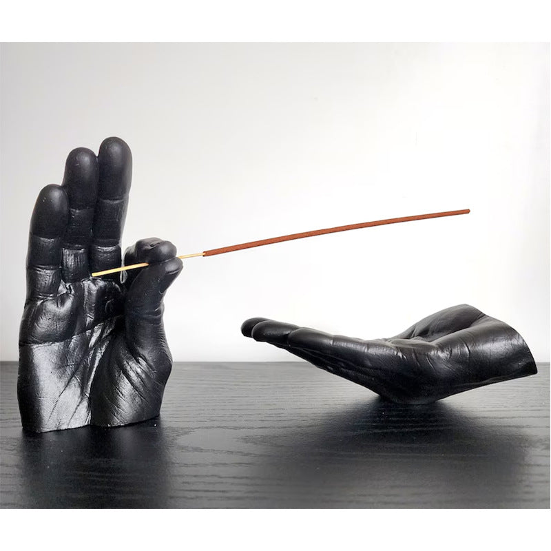 Cartoon-style resin incense holder in the shape of hands, available in black, white, light yellow, and brown. Made from synthetic resin, with a size of 19 * 10 * 10 cm, perfect for holding and receiving incense.
