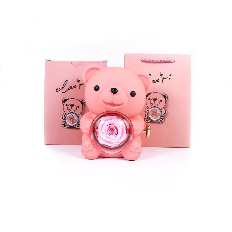 **Rotating Bear Gift Box β Playful & Elegant Packaging π** A **plastic jewelry box** with a **rotating bear design** and **preserved plastic flowers**, perfect for gifting jewelry. Measures **12x13x15.5cm**. Adds charm to your special present! π