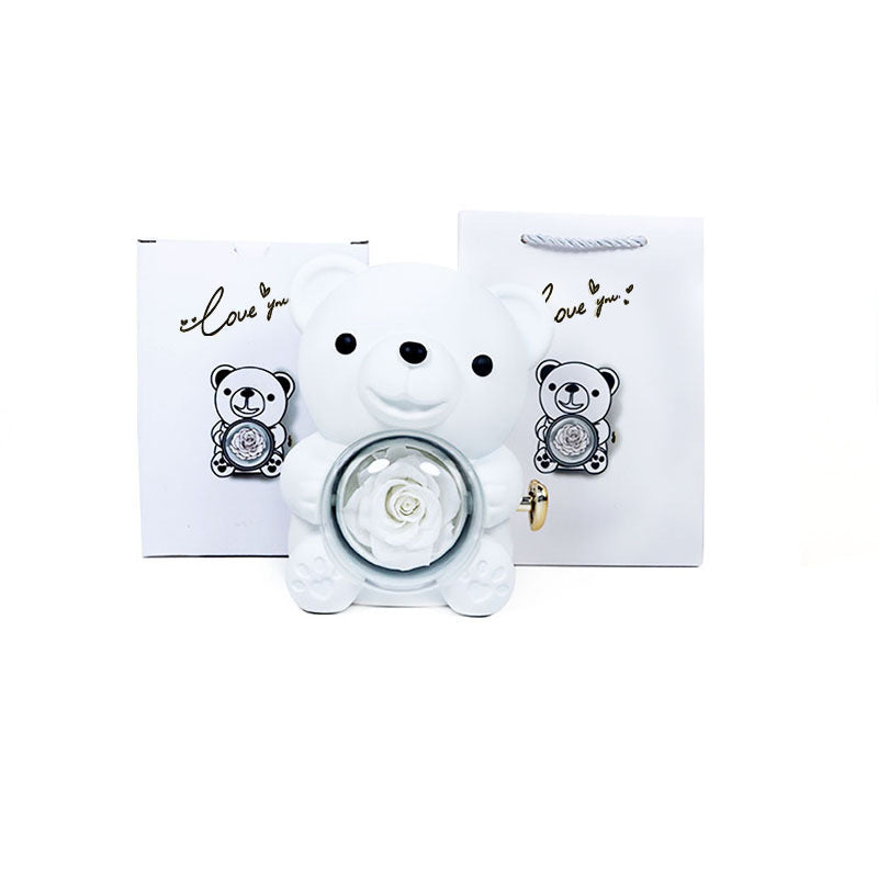 **Rotating Bear Gift Box β Playful & Elegant Packaging π** A **plastic jewelry box** with a **rotating bear design** and **preserved plastic flowers**, perfect for gifting jewelry. Measures **12x13x15.5cm**. Adds charm to your special present! π