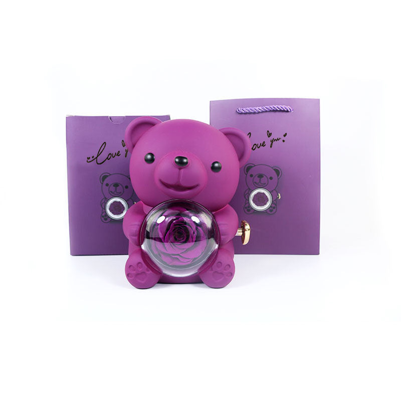 **Rotating Bear Gift Box β Playful & Elegant Packaging π** A **plastic jewelry box** with a **rotating bear design** and **preserved plastic flowers**, perfect for gifting jewelry. Measures **12x13x15.5cm**. Adds charm to your special present! π