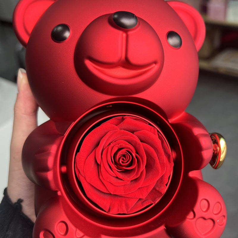 **Rotating Bear Gift Box β Playful & Elegant Packaging π** A **plastic jewelry box** with a **rotating bear design** and **preserved plastic flowers**, perfect for gifting jewelry. Measures **12x13x15.5cm**. Adds charm to your special present! π