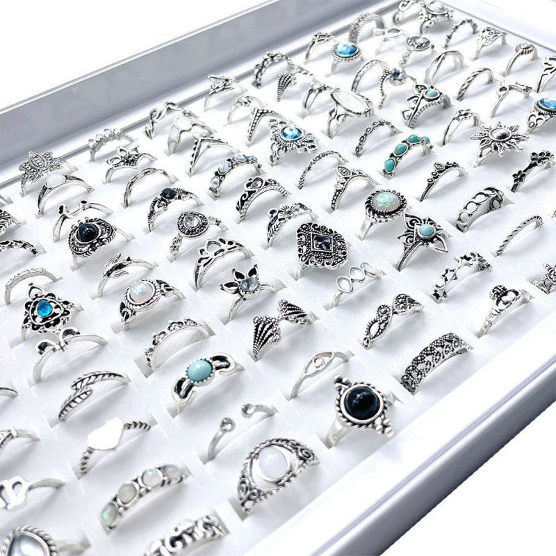 A stylish set of 100 fashion-forward silver alloy rings featuring geometric designs, perfect for adding a trendy touch to any outfit. Each set offers a random selection of styles, ensuring variety and versatility.