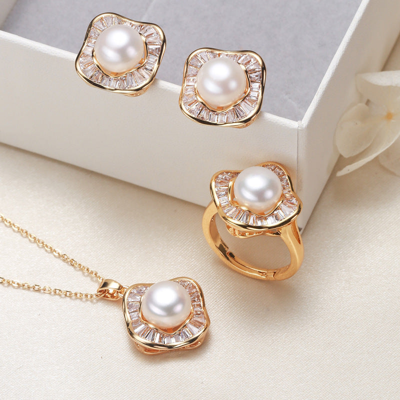 Elegant pearl necklace, ring, and earrings set in various color options, featuring timeless designs and luxurious craftsmanship
