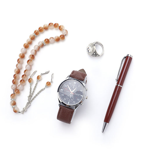 A chic boutique gift set featuring a stylish watch, a rosary, a ring, and a sleek pen, all presented in elegant black and brown color options.