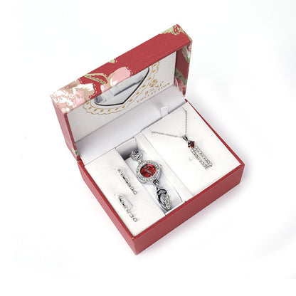  Ladies Jewelry Set featuring alloy material with diamond processing, including earrings, item decorations, hand decorations, and a bamboo link chain with a pendant. Available in red and purple colors, packed individually. Dimensions: 13.5 * 10.5 * 7 cm.
