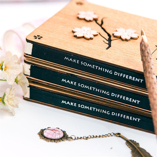 Creative Sakura Notebook Set with carved wooden cover, eco-friendly paper, and crystal bookmark.