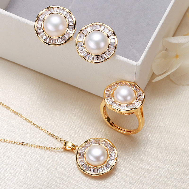 Elegant pearl necklace, ring, and earrings set in various color options, featuring timeless designs and luxurious craftsmanship
