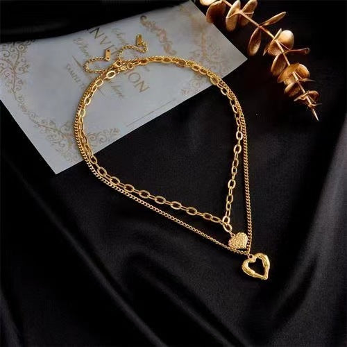 **Love Necklace Gift Set – Stylish & Elegant**  

A beautiful **2-piece necklace set** featuring **heart-shaped** and **geometric pendants** made from **high-quality titanium steel**. Available in **silver** and **golden** colors, with **gold inlaid treatment** for a luxurious finish. The **O-shaped chain** adds comfort and style, perfect for women who love elegant, **Korean-style** accessories.