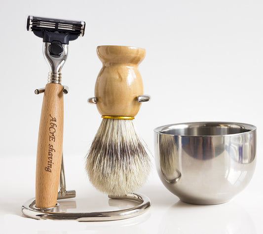 Men's shaving set featuring a metal brush and razor holder made of Fe-Ni alloy, a stainless steel double-layer shaving soap bowl, a 3-layer imported blade razor with a wooden handle, and a bristles shaving brush made from natural bristles. Available in two styles: one with a spare blade and another with two spare blades.
