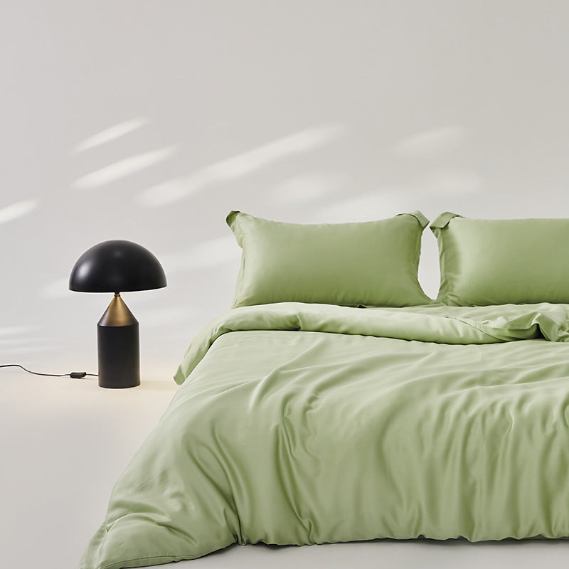 Luxuriously soft Four-Piece Ice Silk Bed Sheets made from breathable Lyocell fiber (Tencel). Features a modern minimalist design, reactive dyeing for long-lasting color, and a silky-smooth texture for year-round comfort. Available in multiple sizes.