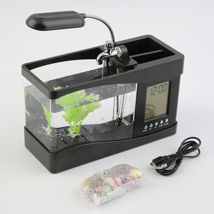 "Mini Aquarium Office Desk Organizer – A multifunctional desk accessory featuring an aquarium, LED table lamp, calendar, alarm, and pen holder, complete with small pebbles and a plant, creating a calming workspace atmosphere."