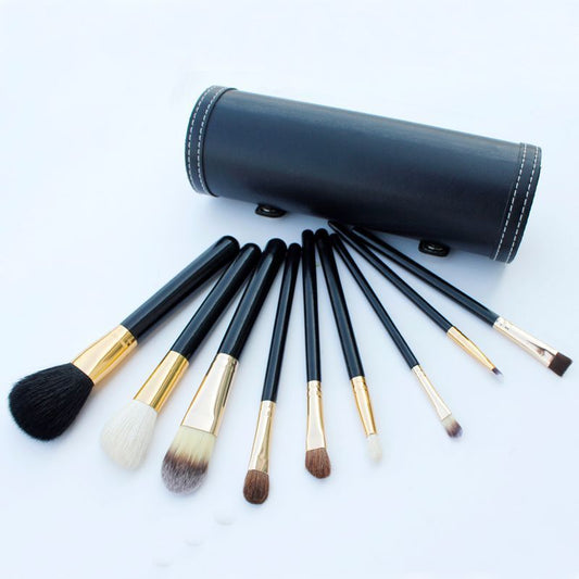 
9-piece Barrel Makeup Brush Set featuring a variety of brushes for powder, foundation, eyeshadow, lips, and eyebrows, crafted with high-quality bristles for precise application.