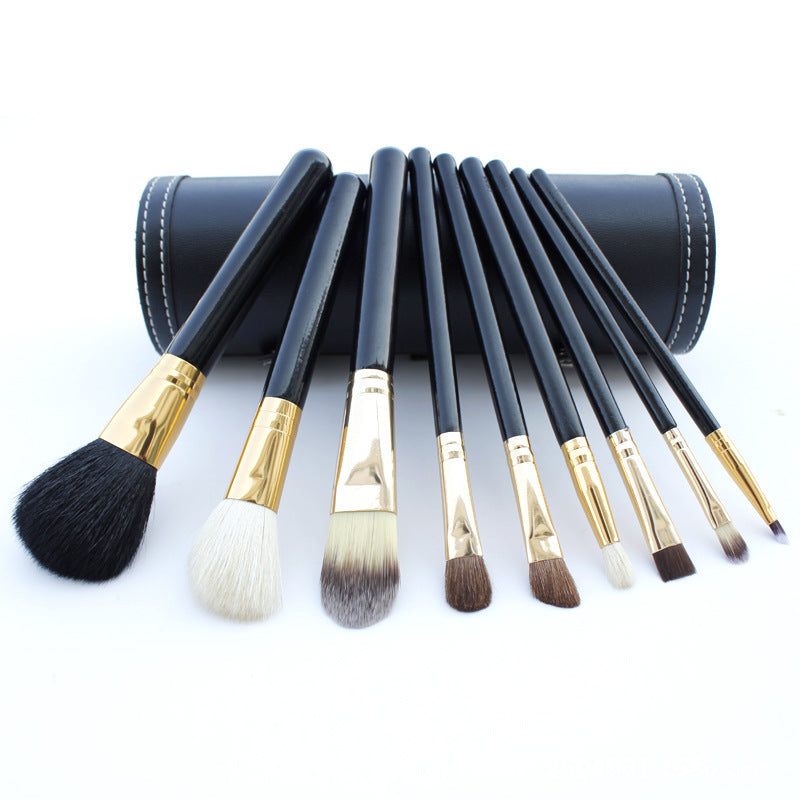 
9-piece Barrel Makeup Brush Set featuring a variety of brushes for powder, foundation, eyeshadow, lips, and eyebrows, crafted with high-quality bristles for precise application.