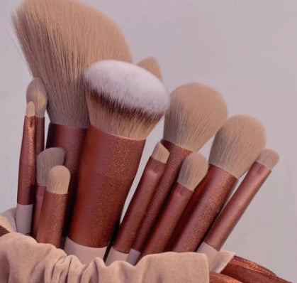 A 13-piece makeup brush set featuring soft synthetic bristles, durable plastic handles, and aluminum ferrules. The set includes brushes for foundation, powder, blush, highlighter, eyeshadow, lip, eyebrow, concealer, and blending. Available in various packaging options such as cloth bags and boxes in green, pink, and yellow. Ideal for professional and personal use, providing precise application and easy cleaning.