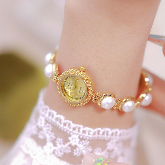 Pearl bracelet women's watch, offering timeless elegance with a fashionable twist for a chic and refined look. #PearlBraceletWatch #TimelessElegance #FashionableTwist #WomensWatch #ChicStyle #LuxuryTimepiece #ElegantAccessories #SophisticatedLook