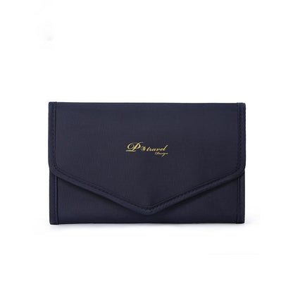 Elegant and portable navy blue travel jewelry bag with multiple compartments for organizing rings, necklaces, and earrings.
