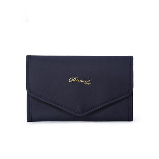 Elegant and portable navy blue travel jewelry bag with multiple compartments for organizing rings, necklaces, and earrings.