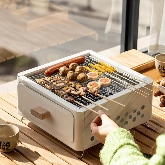 "Square Barbecue Oven-Grill – A white, alloy-constructed grill designed for 3-5 people, featuring a split-type structure, carbon fuel compatibility, and includes a charcoal plate and grill net. Perfect for outdoor gatherings and cookouts."