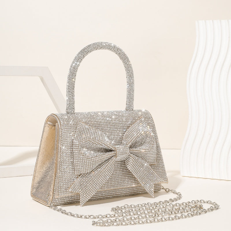 Step into the world of luxury and sophistication with the Elegant Full-Diamond Bow Handbag, a true statement piece that combines timeless elegance with a modern edge. Designed for the fashion-forward, this handbag is a stunning blend of street trend and light luxury style.