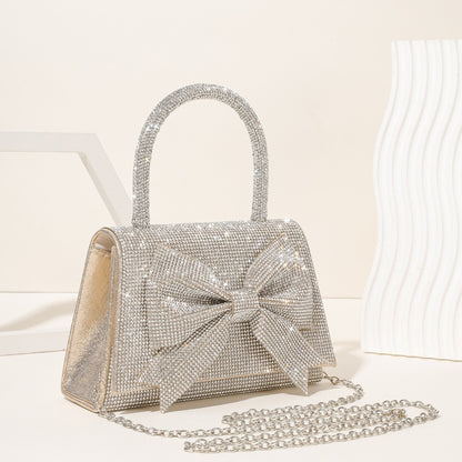 Step into the world of luxury and sophistication with the Elegant Full-Diamond Bow Handbag, a true statement piece that combines timeless elegance with a modern edge. Designed for the fashion-forward, this handbag is a stunning blend of street trend and light luxury style.