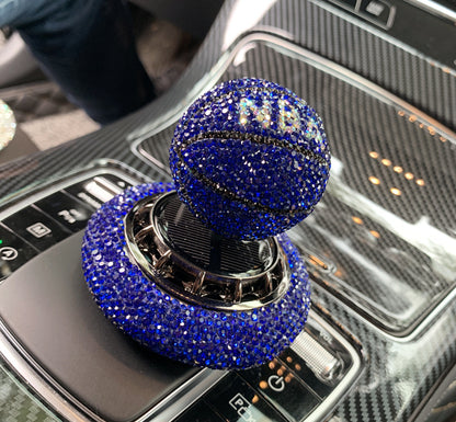 Solar-powered basketball ornament with diamond-encrusted design, rotating with sunlight. Includes solid aromatherapy for a pleasant fragrance. Available in red, white, and blue with a non-slip base.