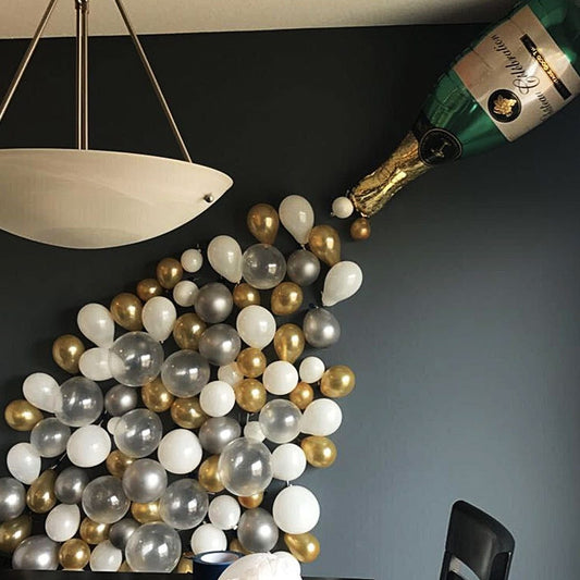 Birthday Party Balloon Decoration set in golden color includes a large wine bottle, 10 golden balloons, 10 silver balloons, 20 gold glitter balloons, and a golden ribbon. Perfect for festive celebrations!