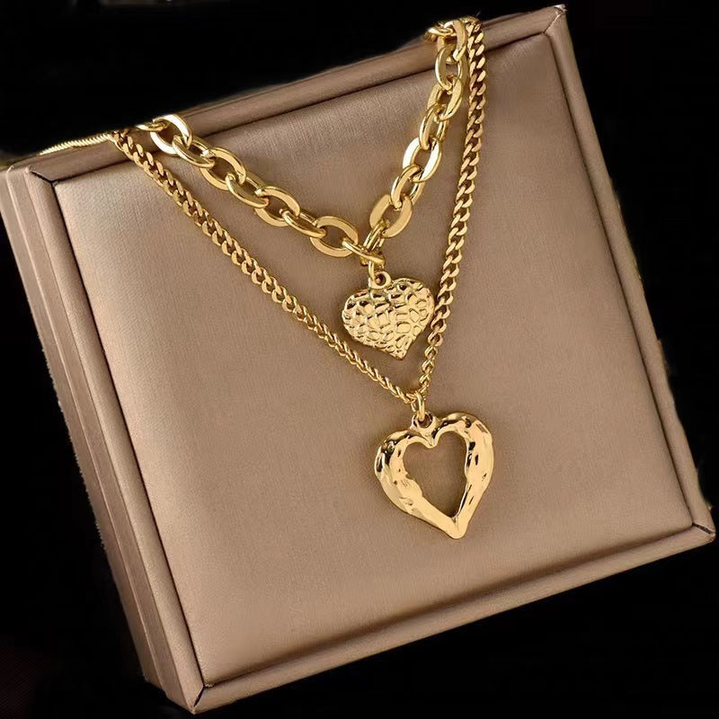**Love Necklace Gift Set – Stylish & Elegant**  

A beautiful **2-piece necklace set** featuring **heart-shaped** and **geometric pendants** made from **high-quality titanium steel**. Available in **silver** and **golden** colors, with **gold inlaid treatment** for a luxurious finish. The **O-shaped chain** adds comfort and style, perfect for women who love elegant, **Korean-style** accessories.