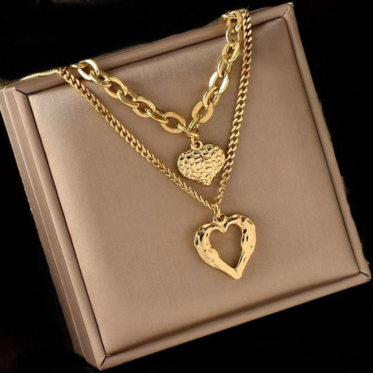 **Love Necklace Gift Set – Stylish & Elegant**  

A beautiful **2-piece necklace set** featuring **heart-shaped** and **geometric pendants** made from **high-quality titanium steel**. Available in **silver** and **golden** colors, with **gold inlaid treatment** for a luxurious finish. The **O-shaped chain** adds comfort and style, perfect for women who love elegant, **Korean-style** accessories.