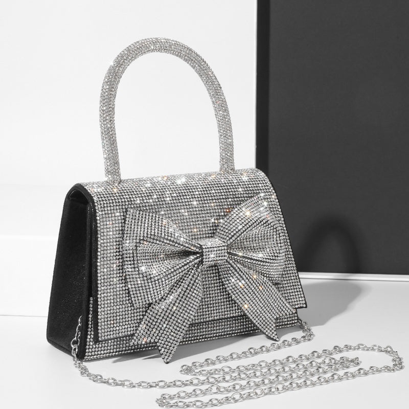 Step into the world of luxury and sophistication with the Elegant Full-Diamond Bow Handbag, a true statement piece that combines timeless elegance with a modern edge. Designed for the fashion-forward, this handbag is a stunning blend of street trend and light luxury style.