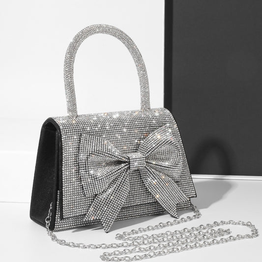 Step into the world of luxury and sophistication with the Elegant Full-Diamond Bow Handbag, a true statement piece that combines timeless elegance with a modern edge. Designed for the fashion-forward, this handbag is a stunning blend of street trend and light luxury style.