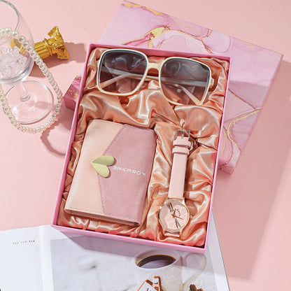 Elegant Women's Watch Business Gift Set featuring a sleek, fashion-forward design. This quartz movement timepiece is adorned with a stylish pointer and number display. The 35mm round dial with a spiral crown ensures precision, while the stainless steel needle buckle offers durability. The set includes a watch, glasses, wallet, and an elegant packaging box, making it a perfect gift choice. Available in square steel belt, pink belt, or white belt styles, this set is designed to impress, ideal for both busines