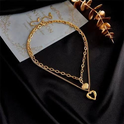 **Love Necklace Gift Set – Stylish & Elegant**  

A beautiful **2-piece necklace set** featuring **heart-shaped** and **geometric pendants** made from **high-quality titanium steel**. Available in **silver** and **golden** colors, with **gold inlaid treatment** for a luxurious finish. The **O-shaped chain** adds comfort and style, perfect for women who love elegant, **Korean-style** accessories.