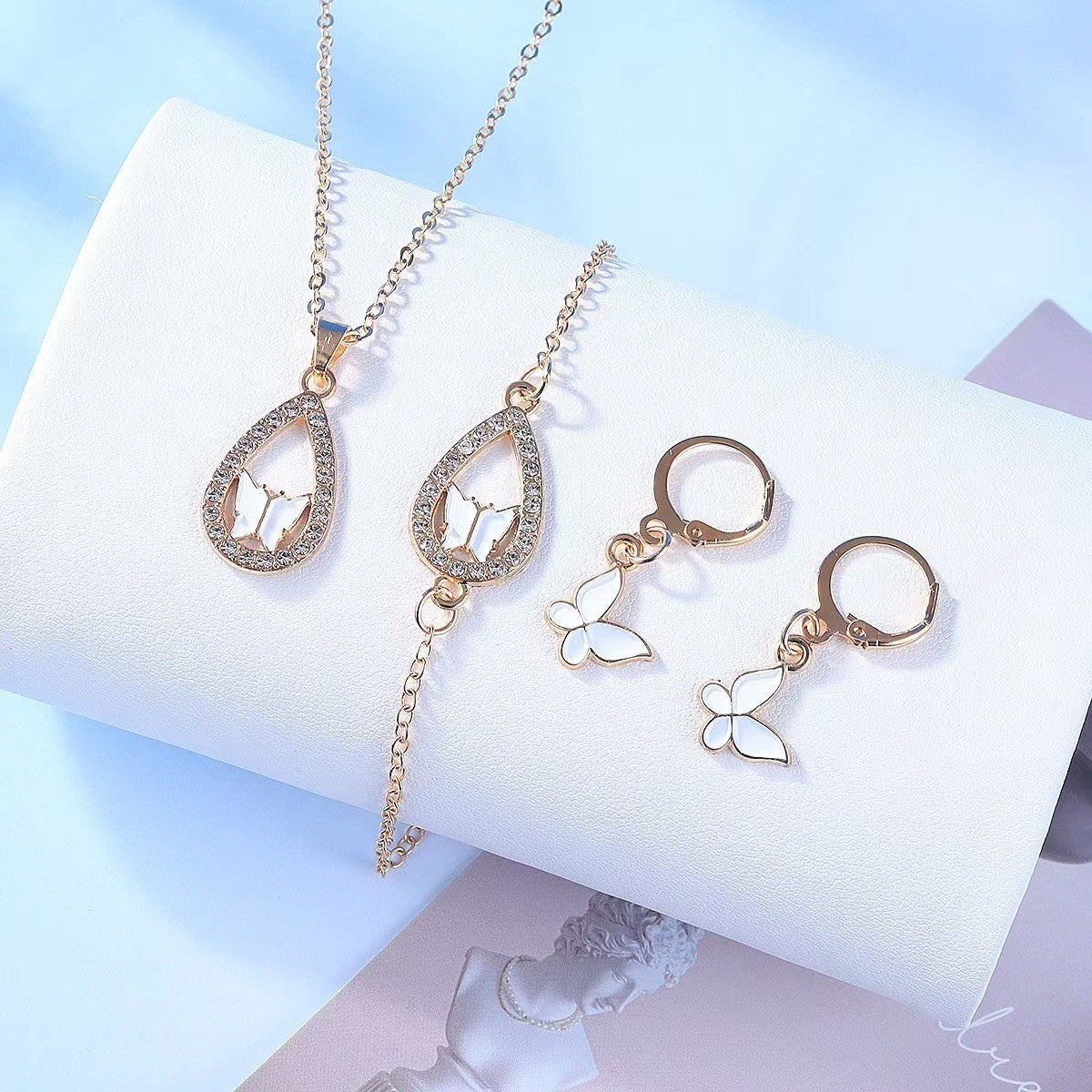 Elegant Butterfly Jewelry Set featuring a necklace, earrings, bracelet, and ring in electroplated alloy, available in red, pink, white, and black.