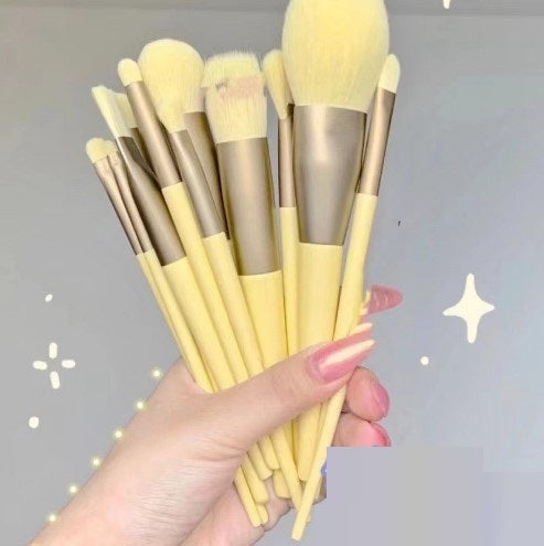 A 13-piece makeup brush set featuring soft synthetic bristles, durable plastic handles, and aluminum ferrules. The set includes brushes for foundation, powder, blush, highlighter, eyeshadow, lip, eyebrow, concealer, and blending. Available in various packaging options such as cloth bags and boxes in green, pink, and yellow. Ideal for professional and personal use, providing precise application and easy cleaning.