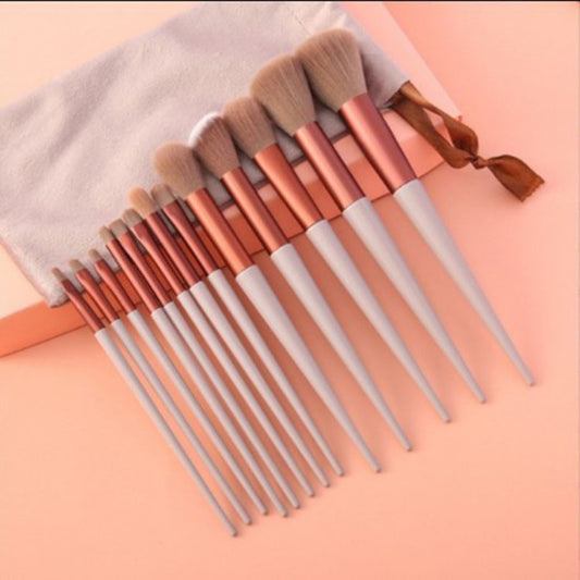 A 13-piece makeup brush set featuring soft synthetic bristles, durable plastic handles, and aluminum ferrules. The set includes brushes for foundation, powder, blush, highlighter, eyeshadow, lip, eyebrow, concealer, and blending. Available in various packaging options such as cloth bags and boxes in green, pink, and yellow. Ideal for professional and personal use, providing precise application and easy cleaning.