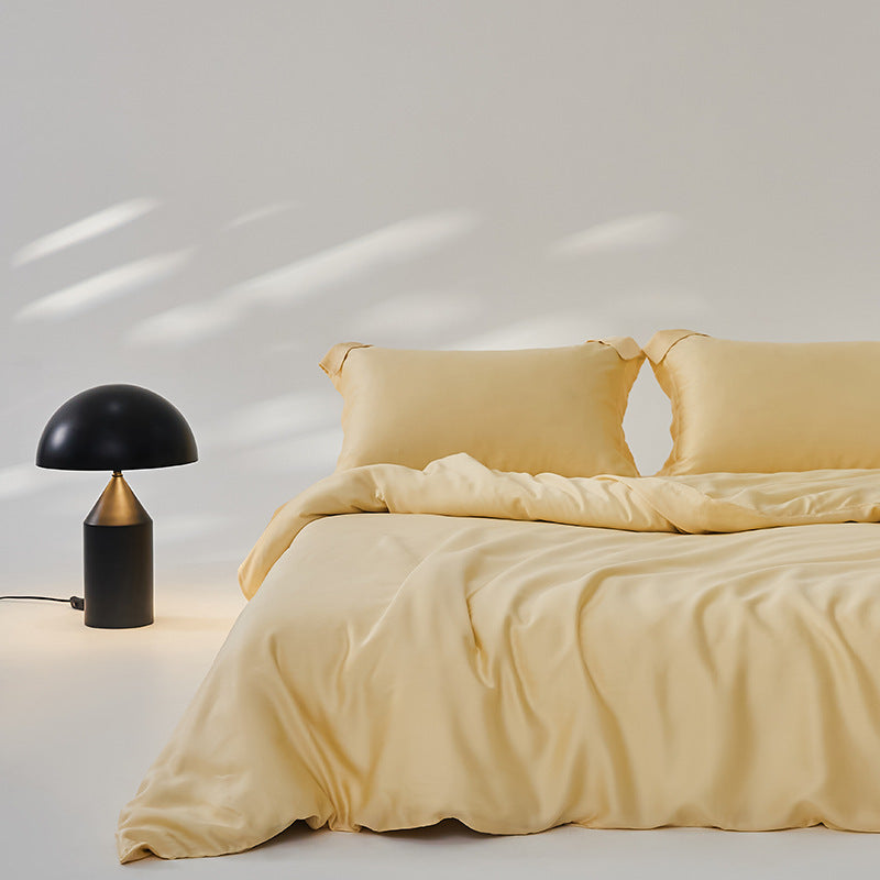 Luxuriously soft Four-Piece Ice Silk Bed Sheets made from breathable Lyocell fiber (Tencel). Features a modern minimalist design, reactive dyeing for long-lasting color, and a silky-smooth texture for year-round comfort. Available in multiple sizes.